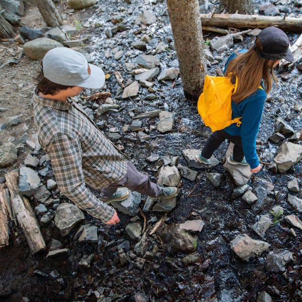 Walking across a stream in the Oboz Hyalite waterproof hiking boots.