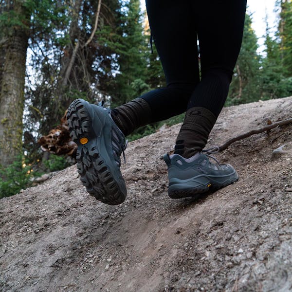 Oboz Sawtooth Ascent hiking boot on a rocky trail in Montana.