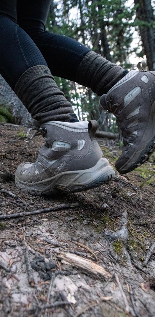 Hiking up a trail in the Oboz Sawtooth Ascent Mid hiking boots.