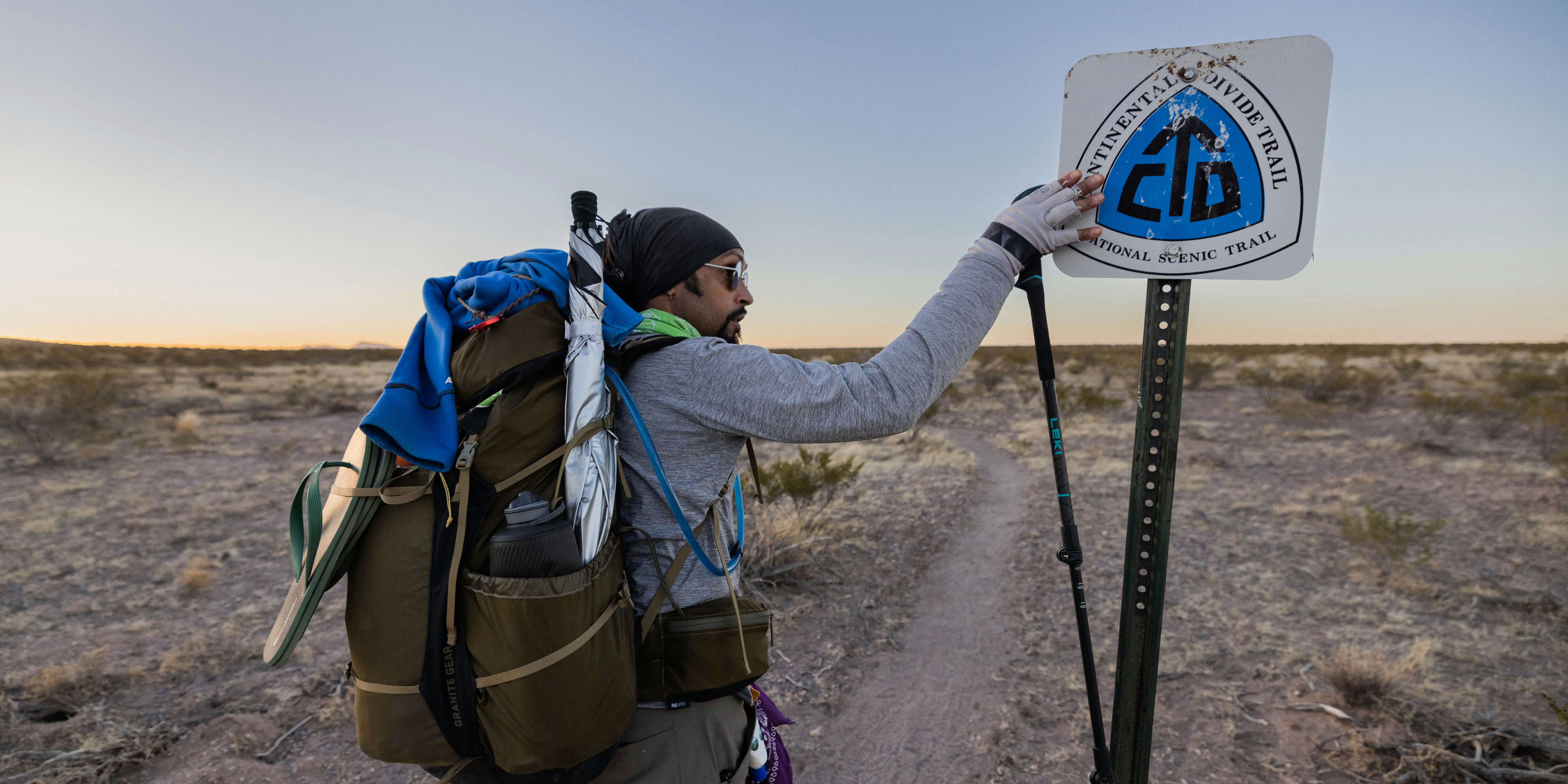 Derick Lugo with a Continental Divide Trail sign while thru hiking.