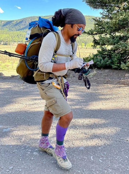 Derrick Lugo journaling while hiking the Continental Divide Trail.