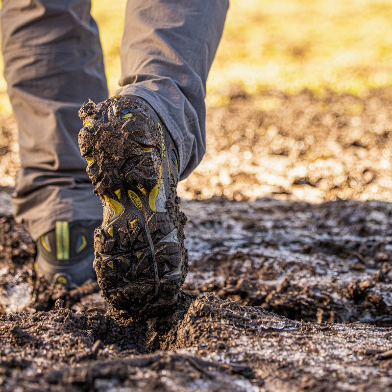 Mens sawtooth ii hiking boot going through a muddy trail