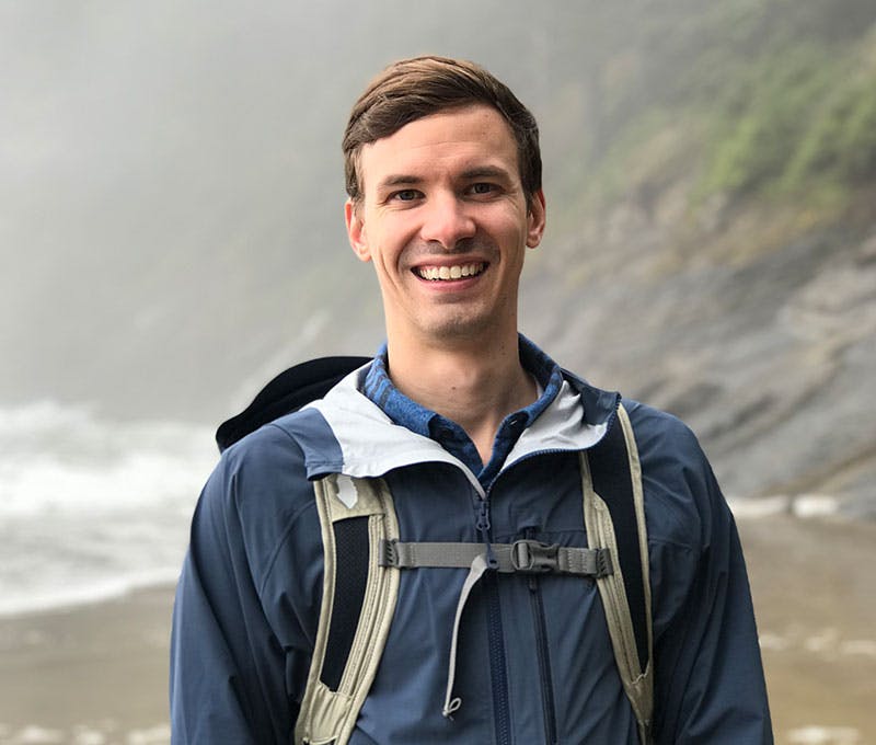 Sean Larson hiking on a beach