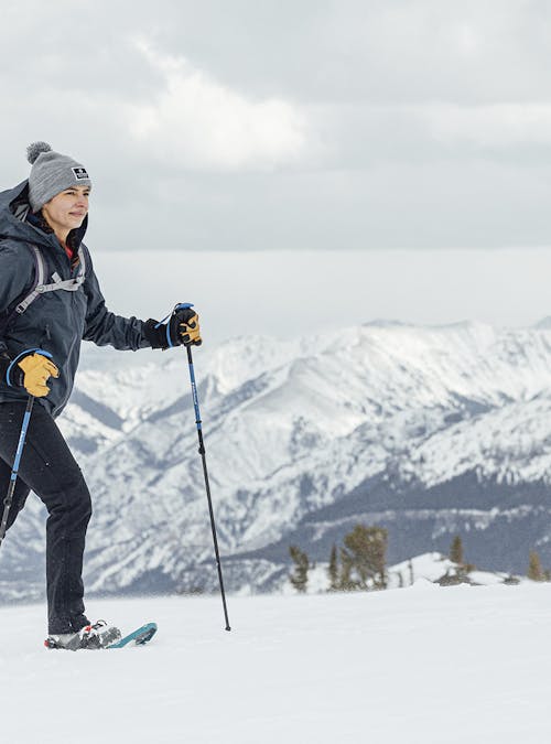 Woman snowshoes in the Oboz Bangtail insulated hiking boots