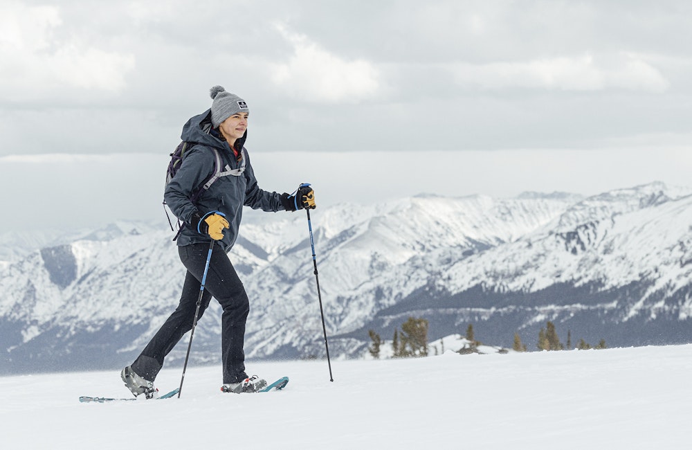 Woman snowshoeing in in the backcountry wearing Oboz winter boots.