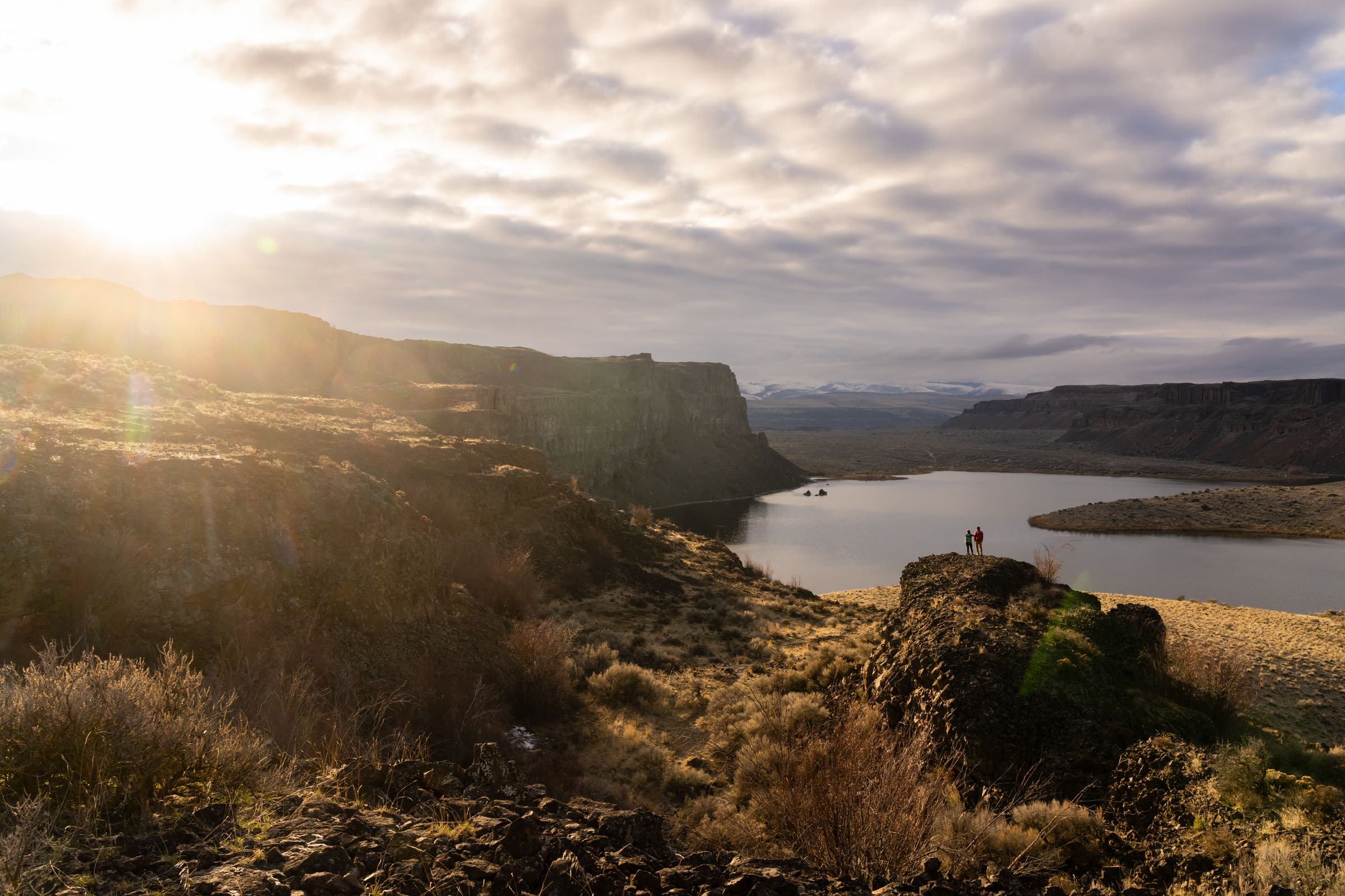 Two hikers enjoying a gorgeous river view in Montana.