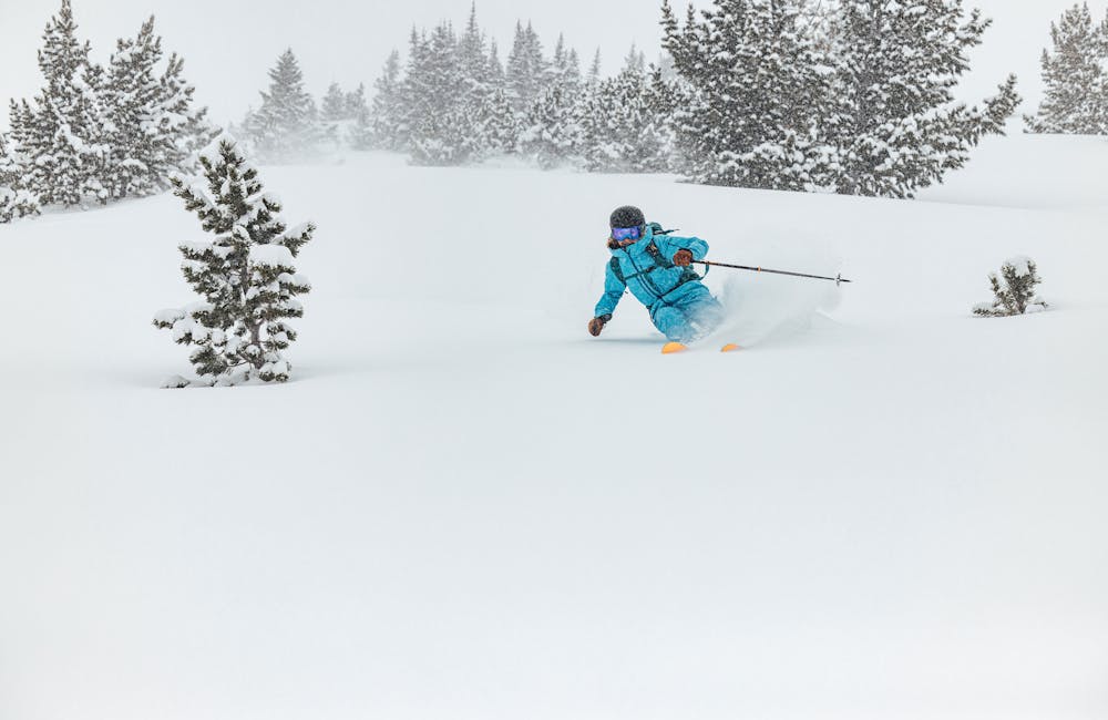 A woman skiing in the Montana backcountry with Oboz and Skida