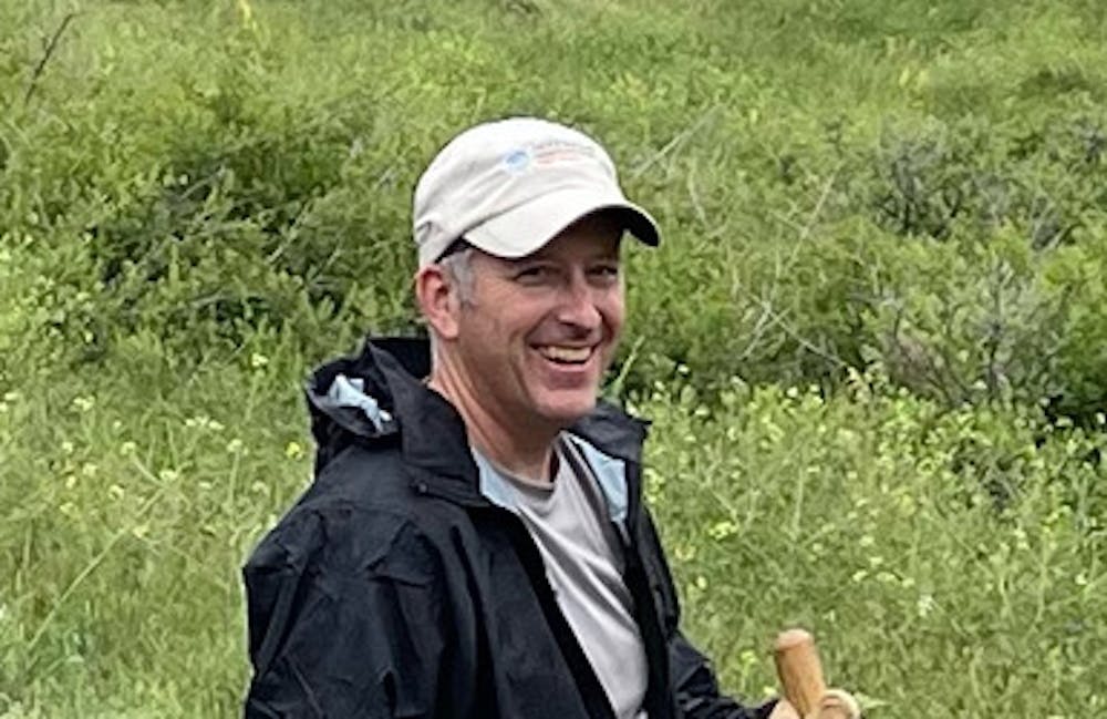 Oboz Local Hero, Dan Cavaliere, stands with a shovel on a recent trail work day.