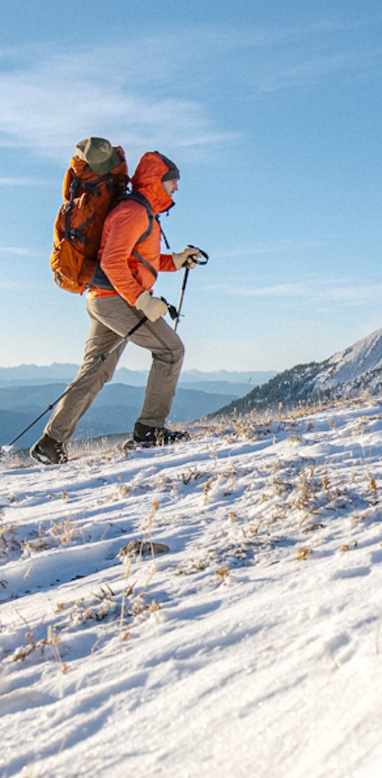 Jay Broccolo hiking in Oboz hiking boots in the snowy mountains of Montana.