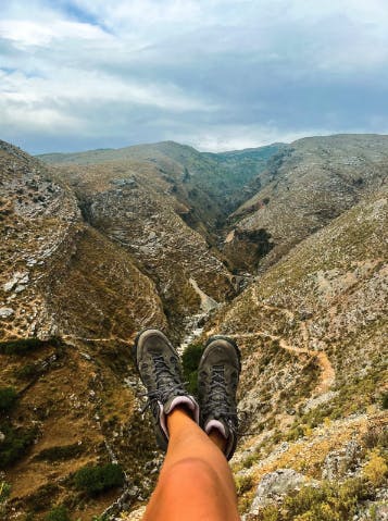 Woman enjoying summit views in the Sawtooth X Mid hiking shoes