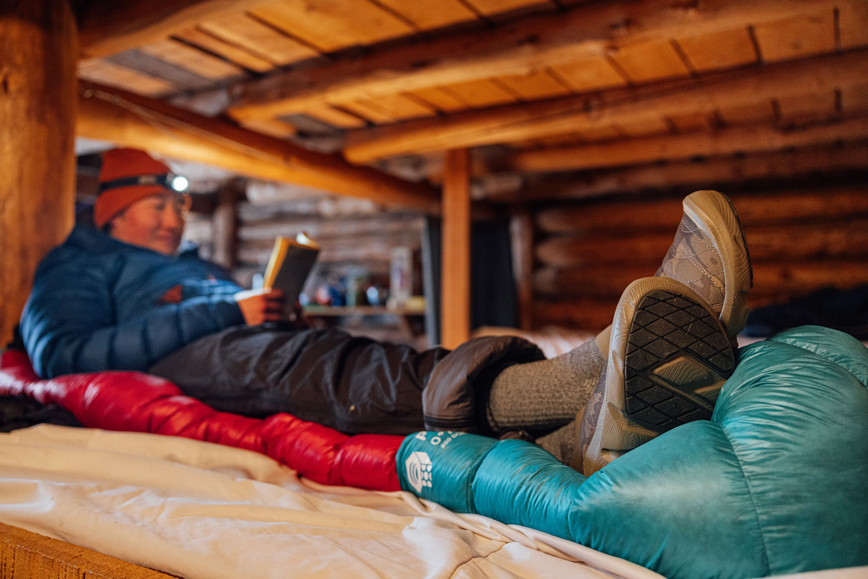 Reading a book in the Oboz Whakatā Low Print slipper shoes.