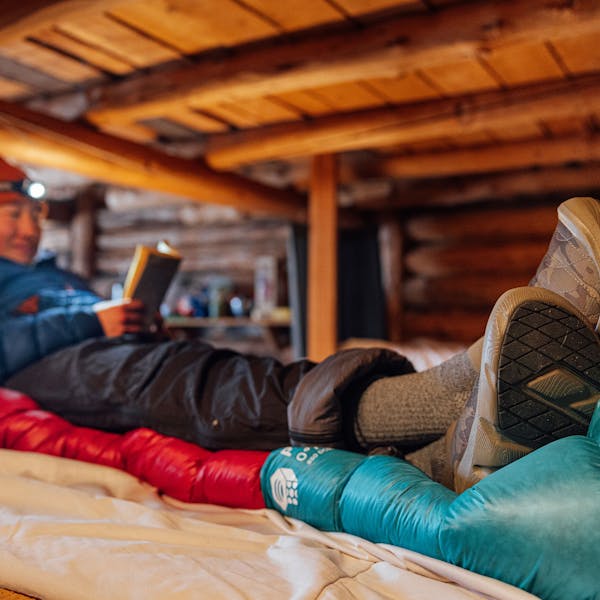 Reading a book in the Oboz Whakatā Low Print slipper shoes.