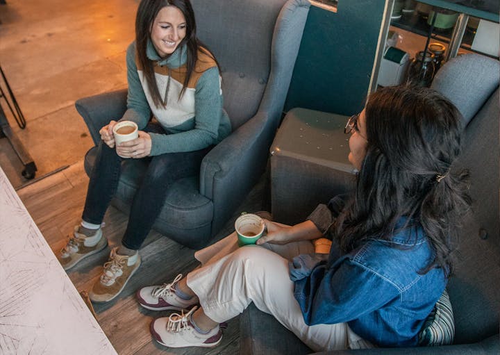 Relaxing over coffee with wearing the Oboz Emma Low and Hazel Mid women's casual shoes.
