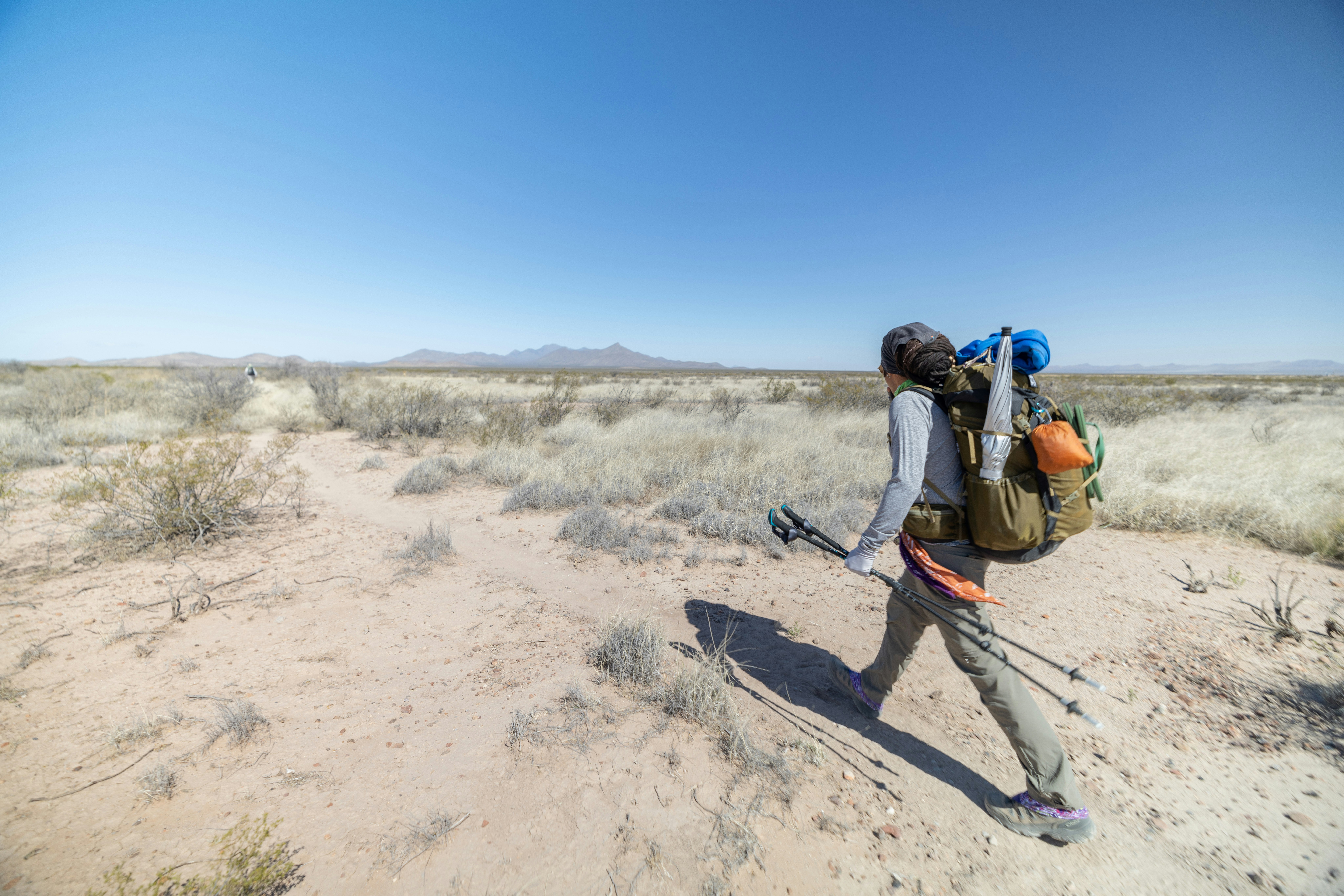 Derick Lugo thru hiking on a desert trail on the Continental Divide Trail.