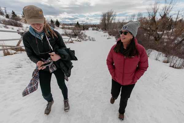 Amy Beck and a friend hiking on the snowy trails of Peet's Hill in Bozeman, Montana while wearing winter Oboz boots.