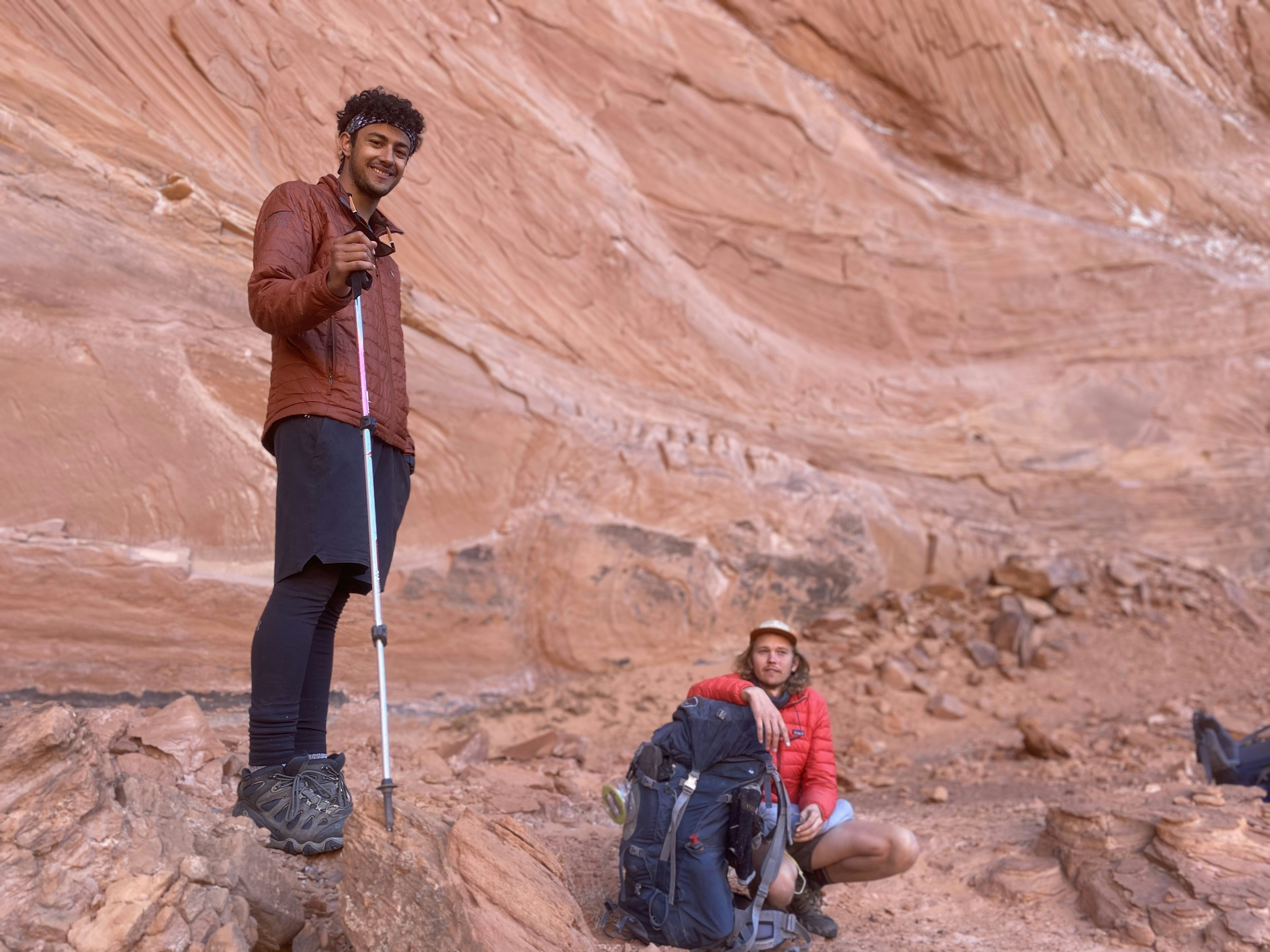 Two backpackers take a rest in the canyon shade wearing Oboz hiking boots