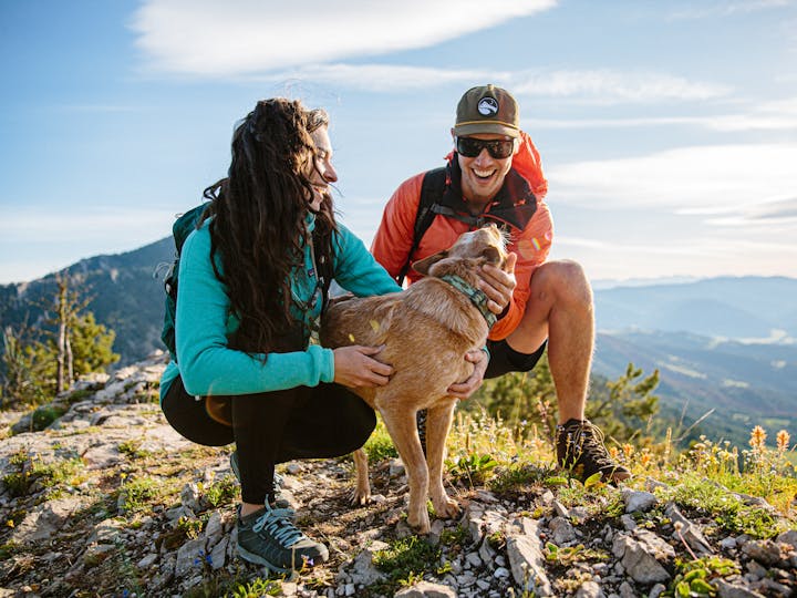 A couple hikes with their dog in Bozeman, Montana.