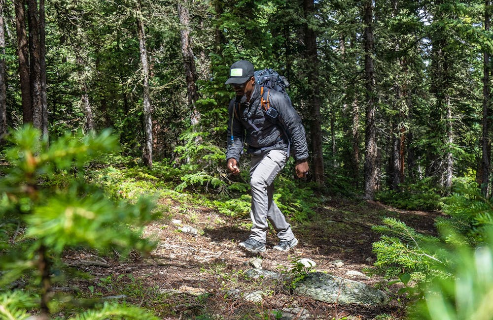 Oboz Footwear Trailblazer Evan Gill hiking in the forest.