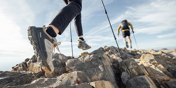 Two hikers on rocky terrain wearing the Oboz Katabatic Low hiking shoes.