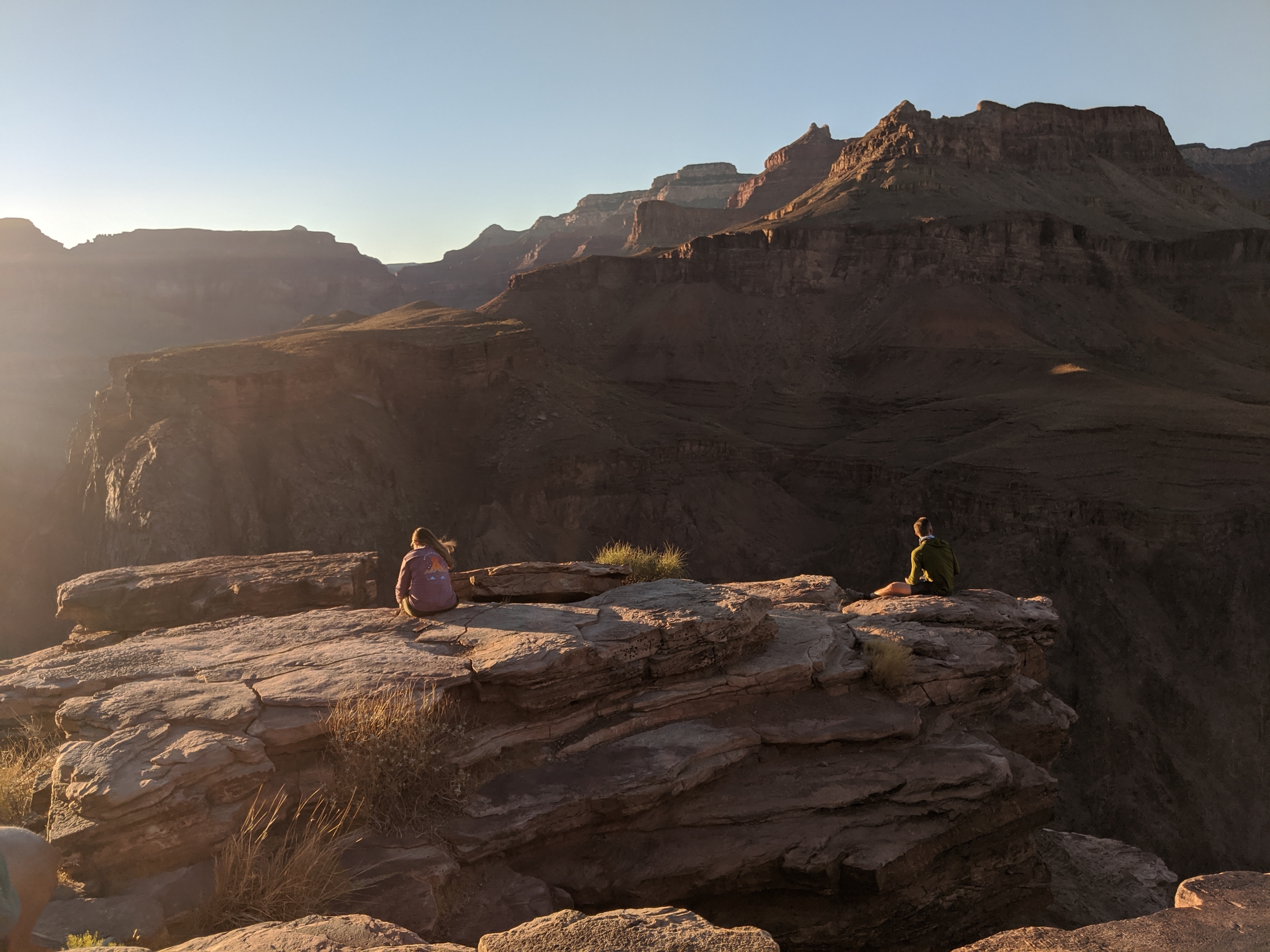 Hiker overlooking canyon on a bright, sunny day