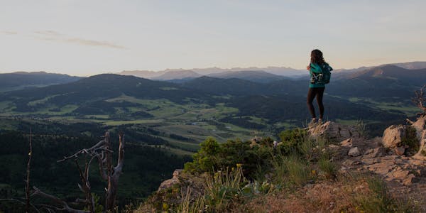 Oboz Footwear Ambassador Jackie Nourse looking at a beautiful mountain view near Bozeman, MT.