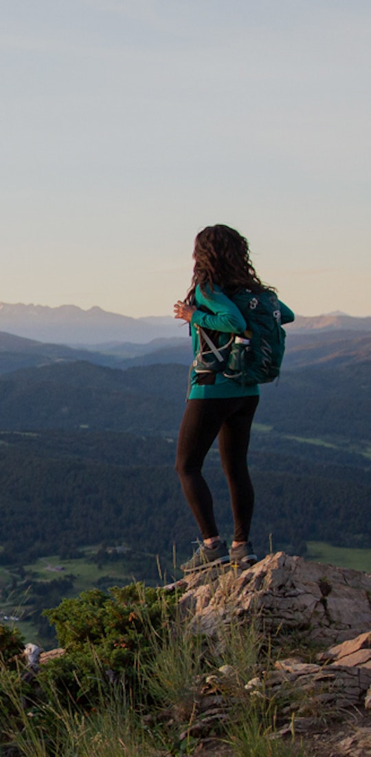 Jackie Nourse overlooking mountain views surrounding Bozeman, MT wearing Oboz hiking boots.