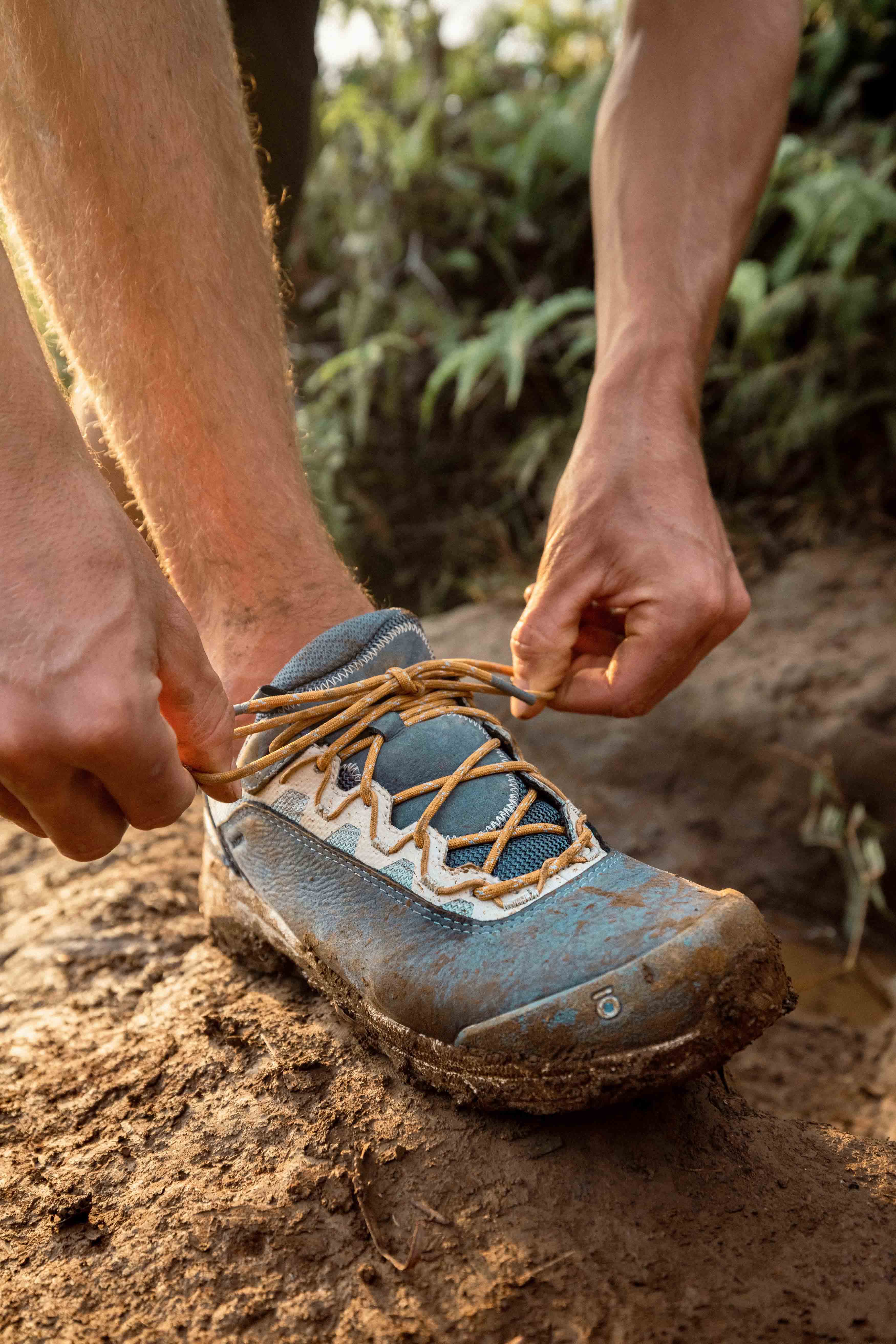 Oboz Cottonwood Low Waterproof hiking shoe on a muddy trail.